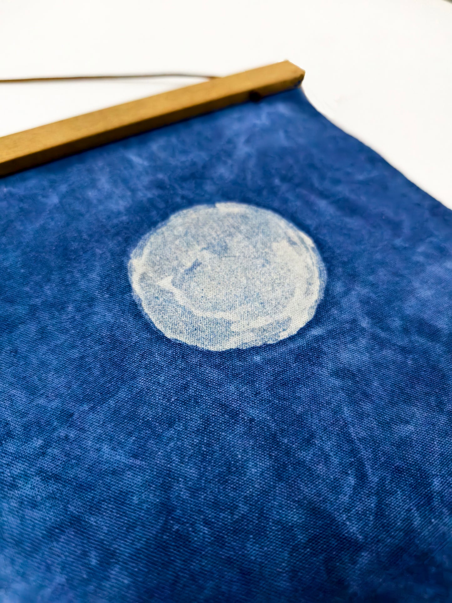 Blue fabric with a white circular design on a white background