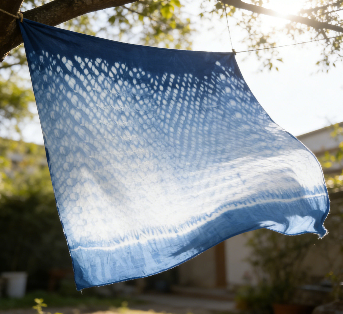 Blue fabric with a textured pattern hanging outdoors