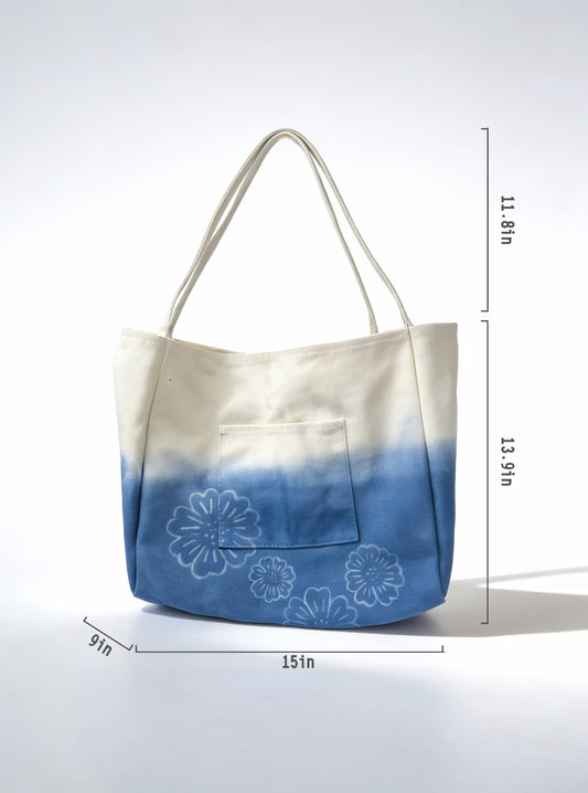 Gradient tote bag with floral embroidery and measurements on a white background