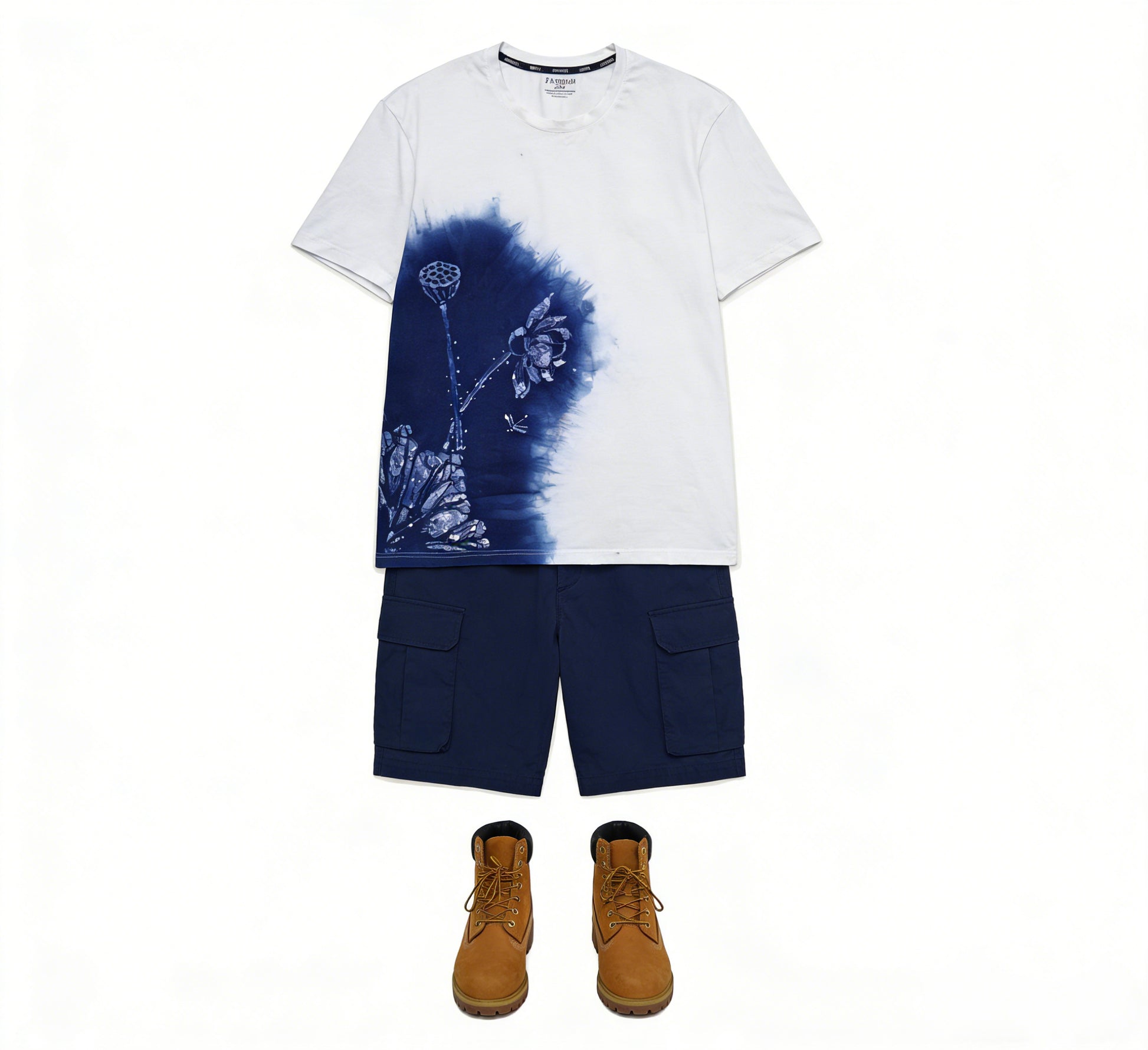 White t-shirt with blue floral design, navy cargo shorts, and brown boots on a white background