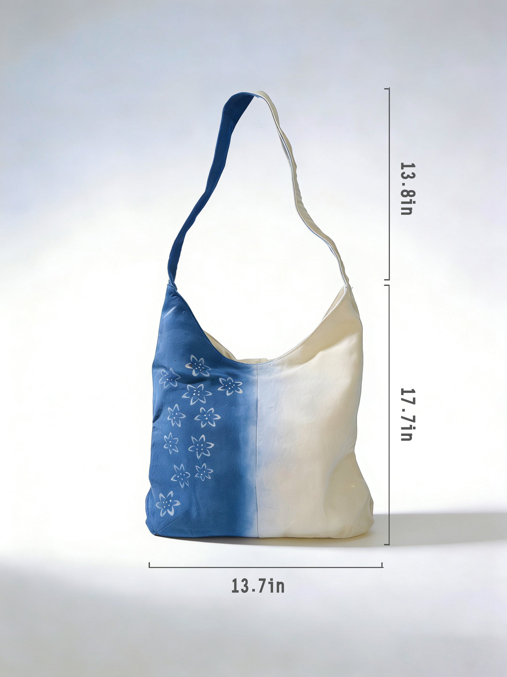 Blue and white bag with floral patterns on a light gray background