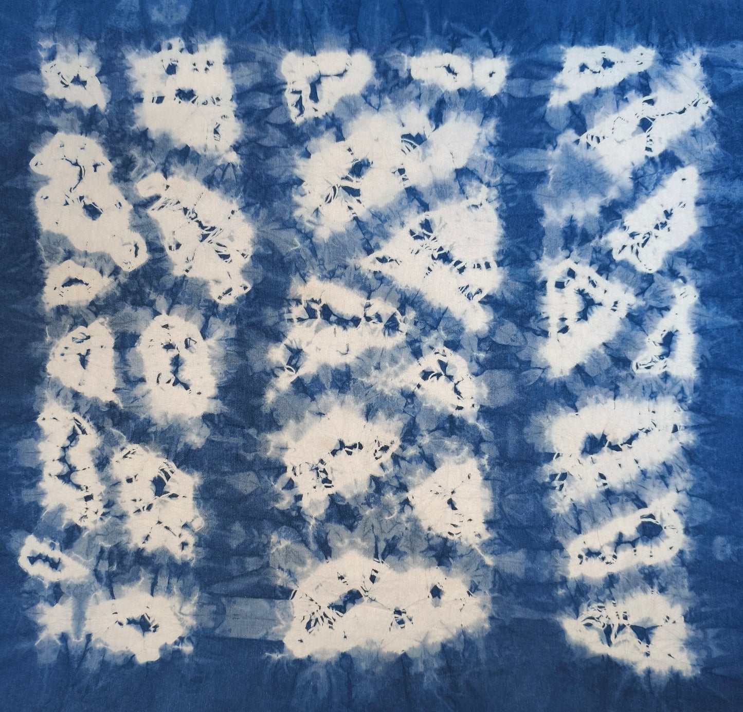 Tie-dye pattern with white and blue colors on a fabric background