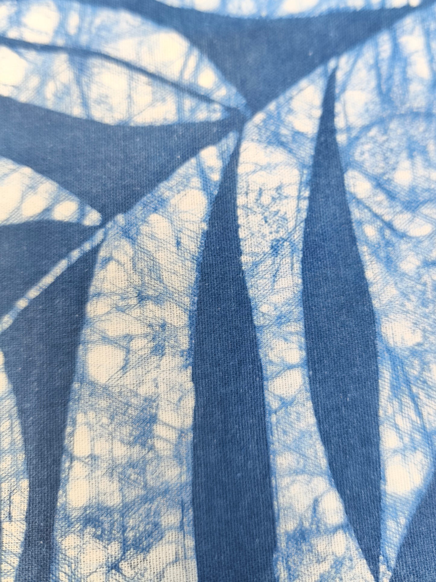 Close-up of a fabric with a batik pattern featuring blue and white colors.