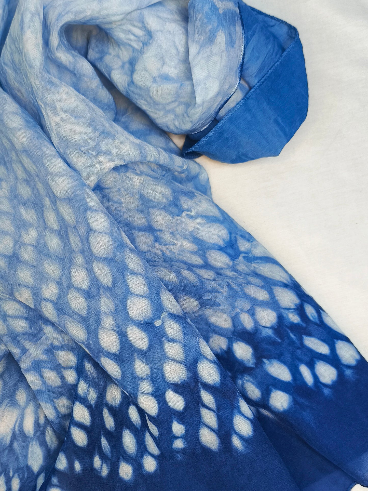 Blue and white patterned fabric on a white background