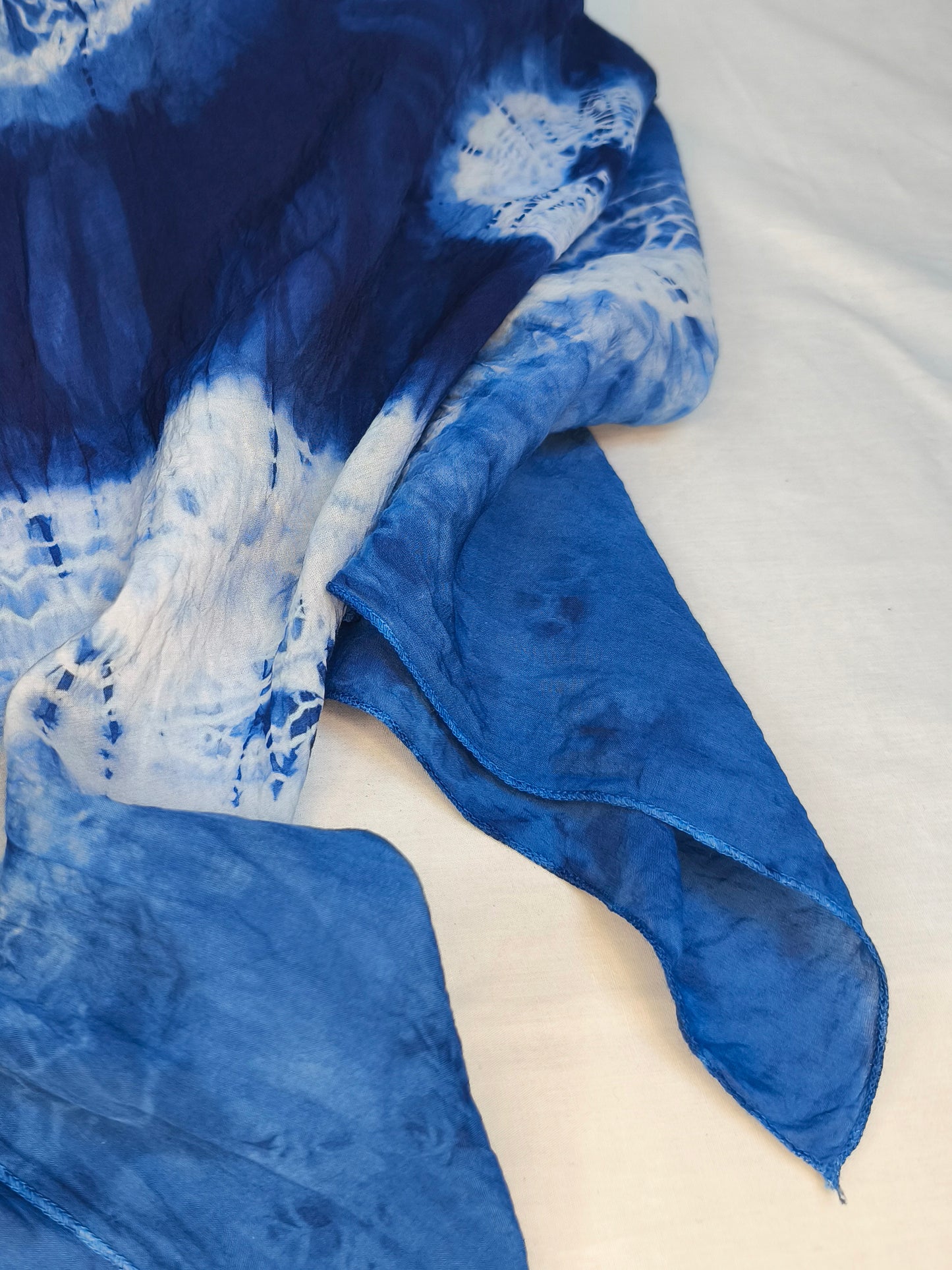 Blue and white tie-dye fabric on a white background