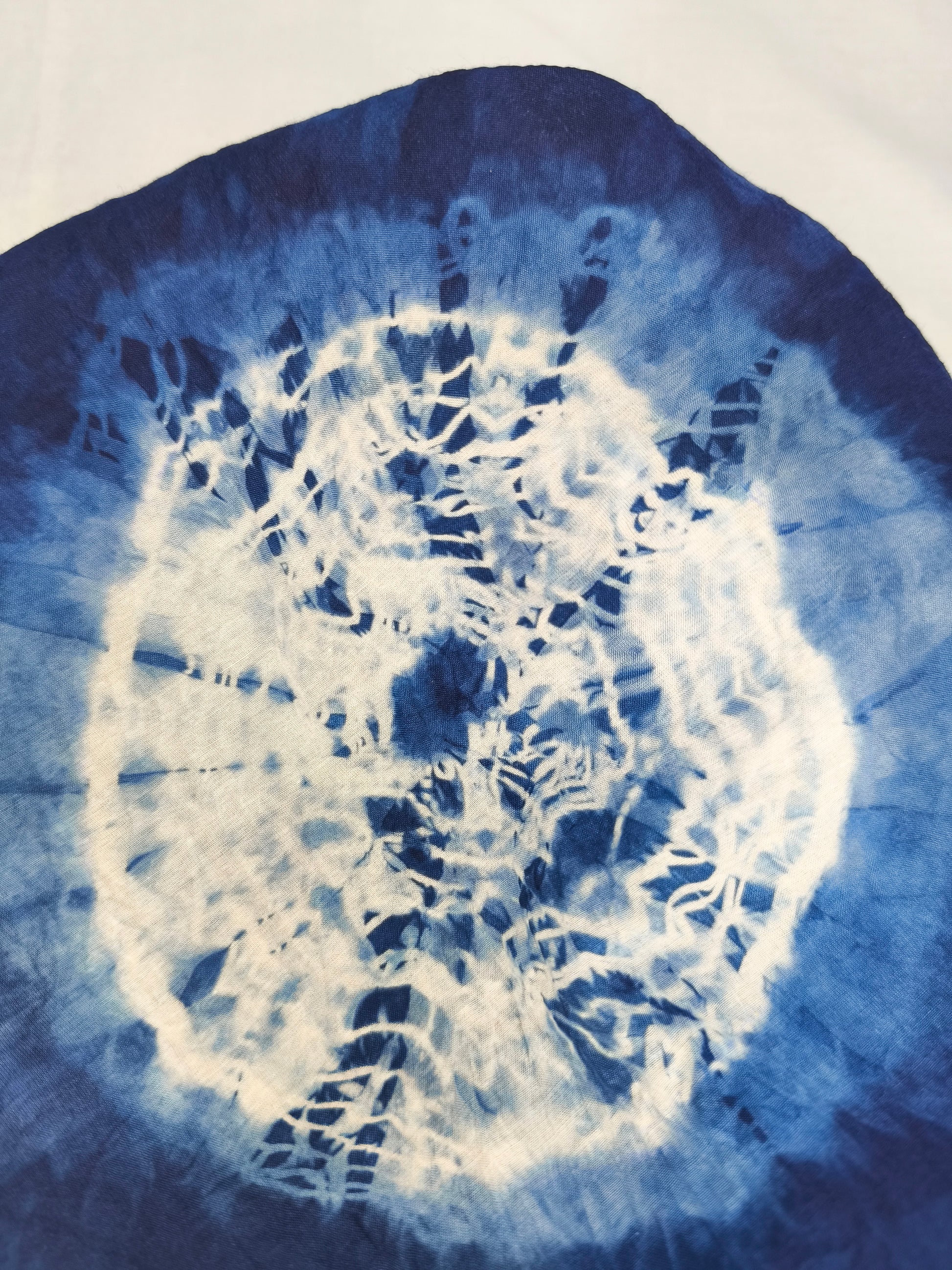 Blue and white tie-dye pattern on a fabric swatch