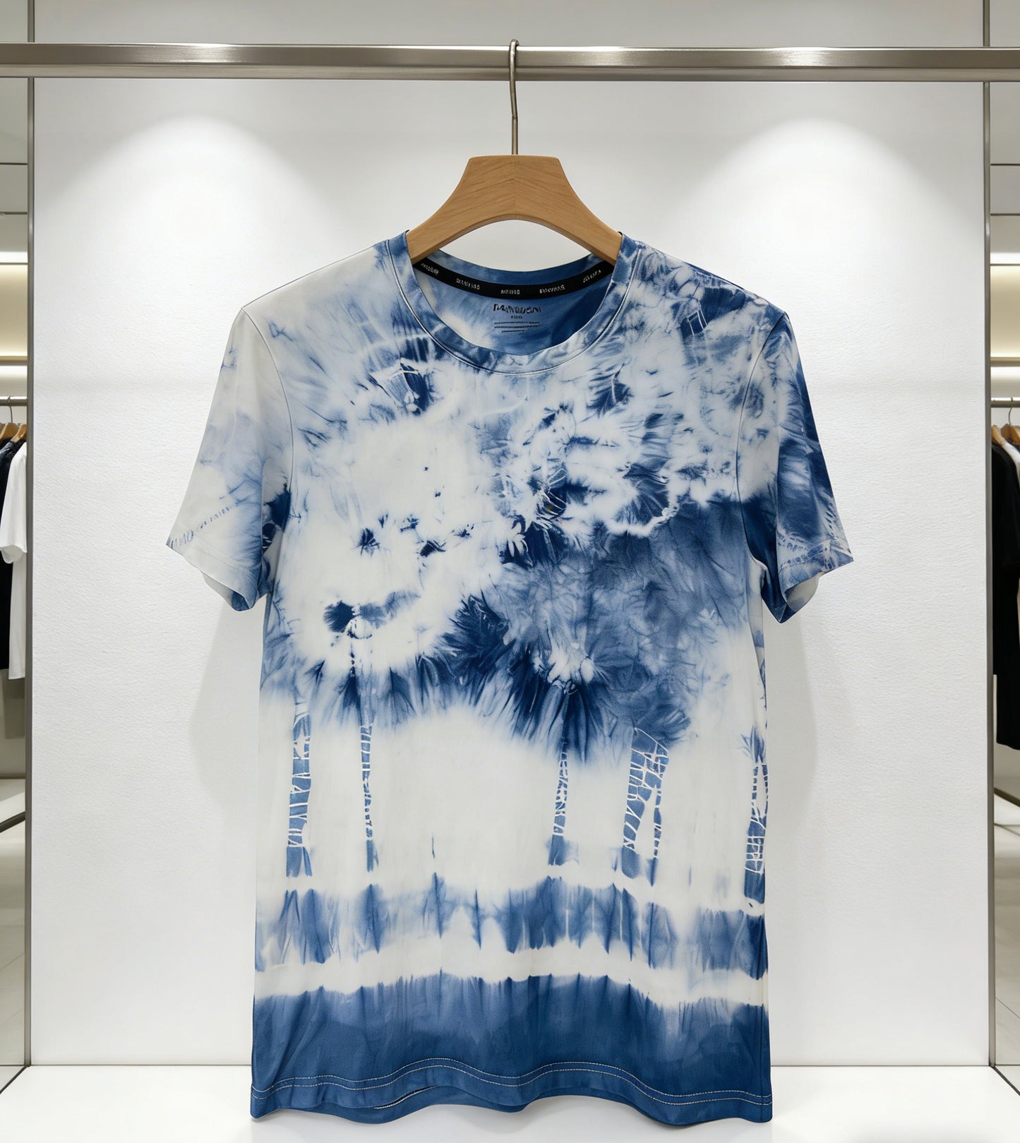 Blue and white tie-dye t-shirt on a hanger against a light background