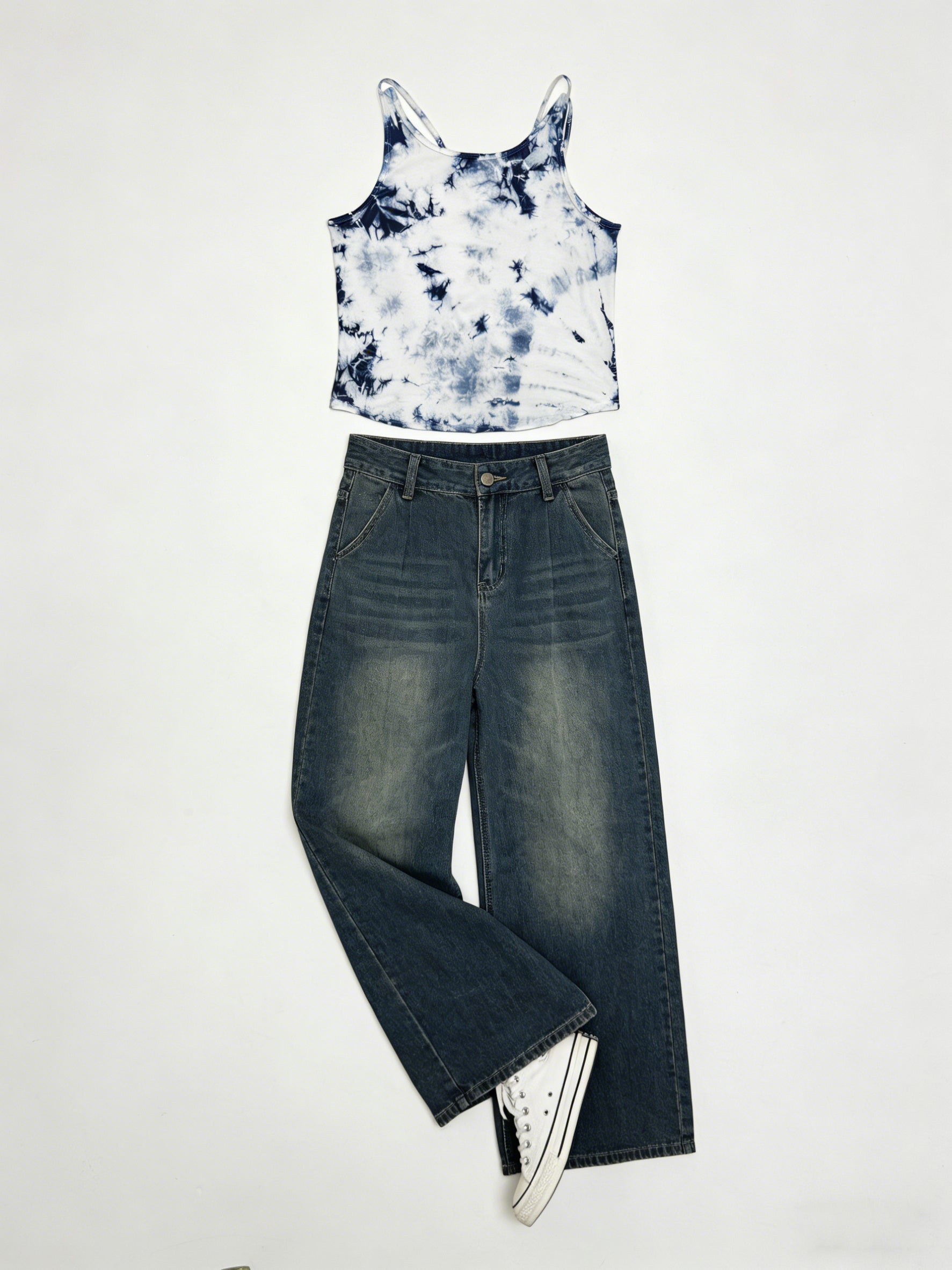 Tie-dye crop top and wide-leg jeans on a white background
