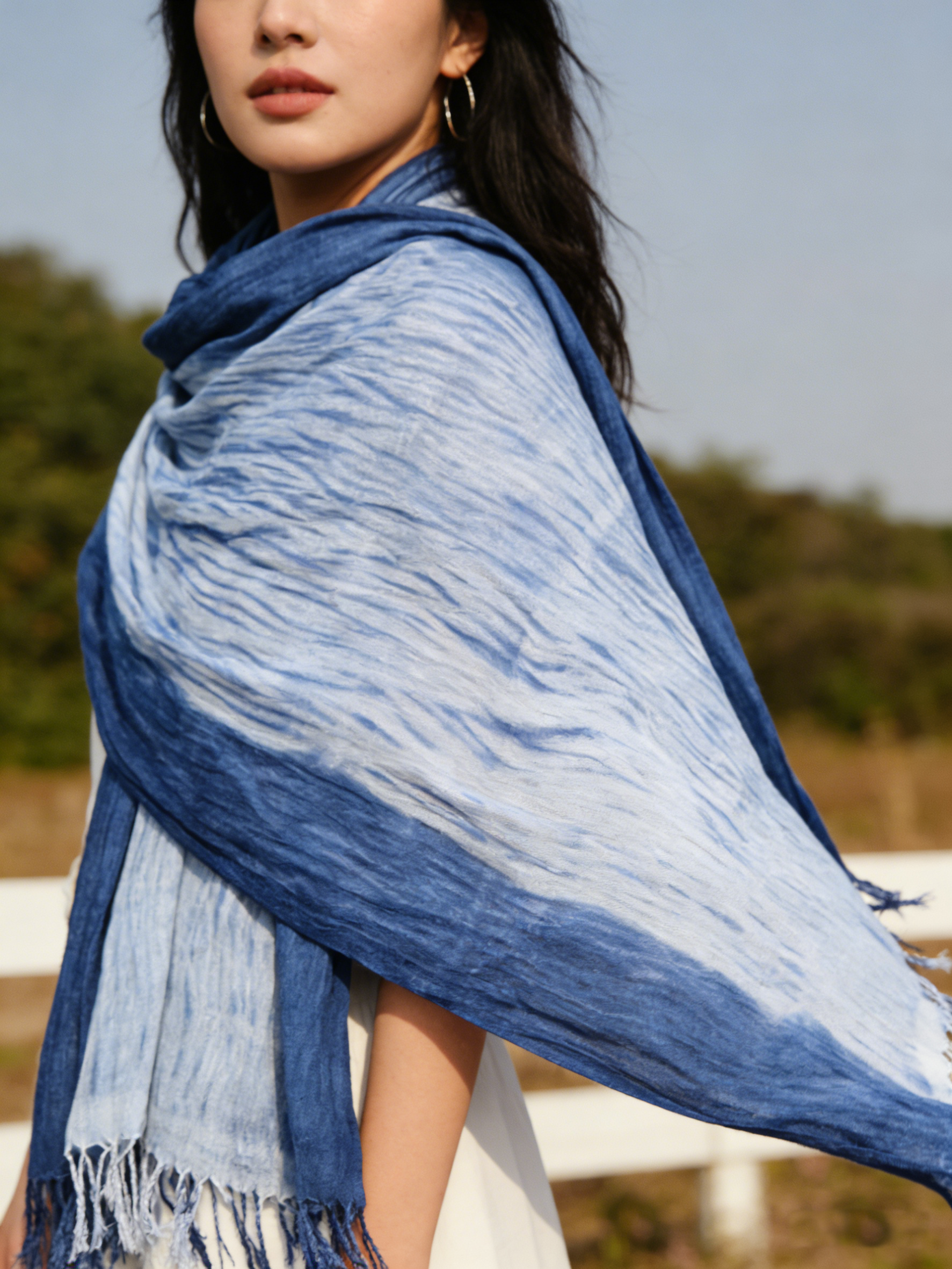 Woman wearing a blue and white patterned scarf outdoors