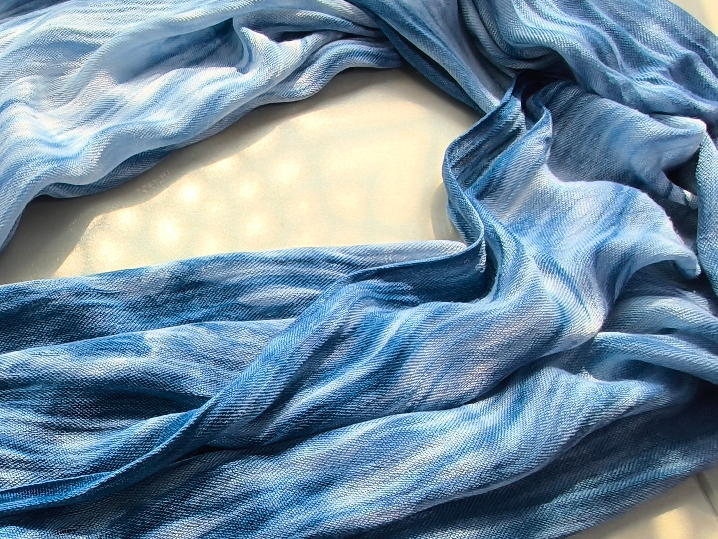 Blue fabric with a subtle pattern on a light background