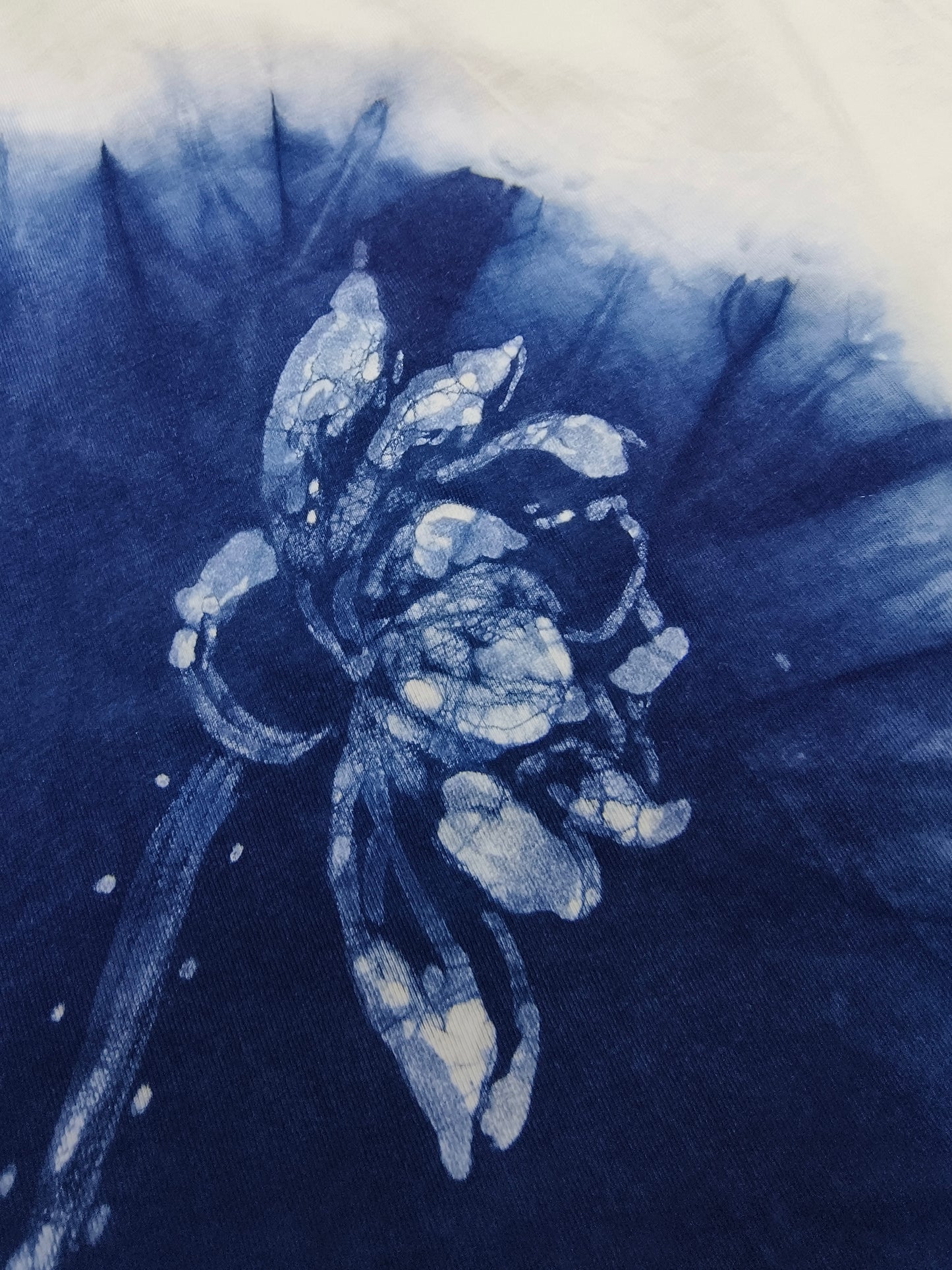 Blue and white floral design on a textured fabric background