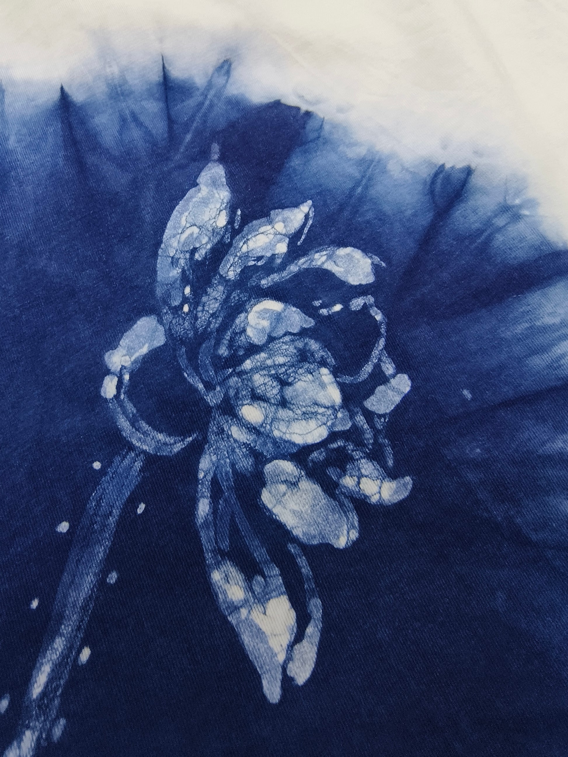Blue and white floral design on a textured fabric background