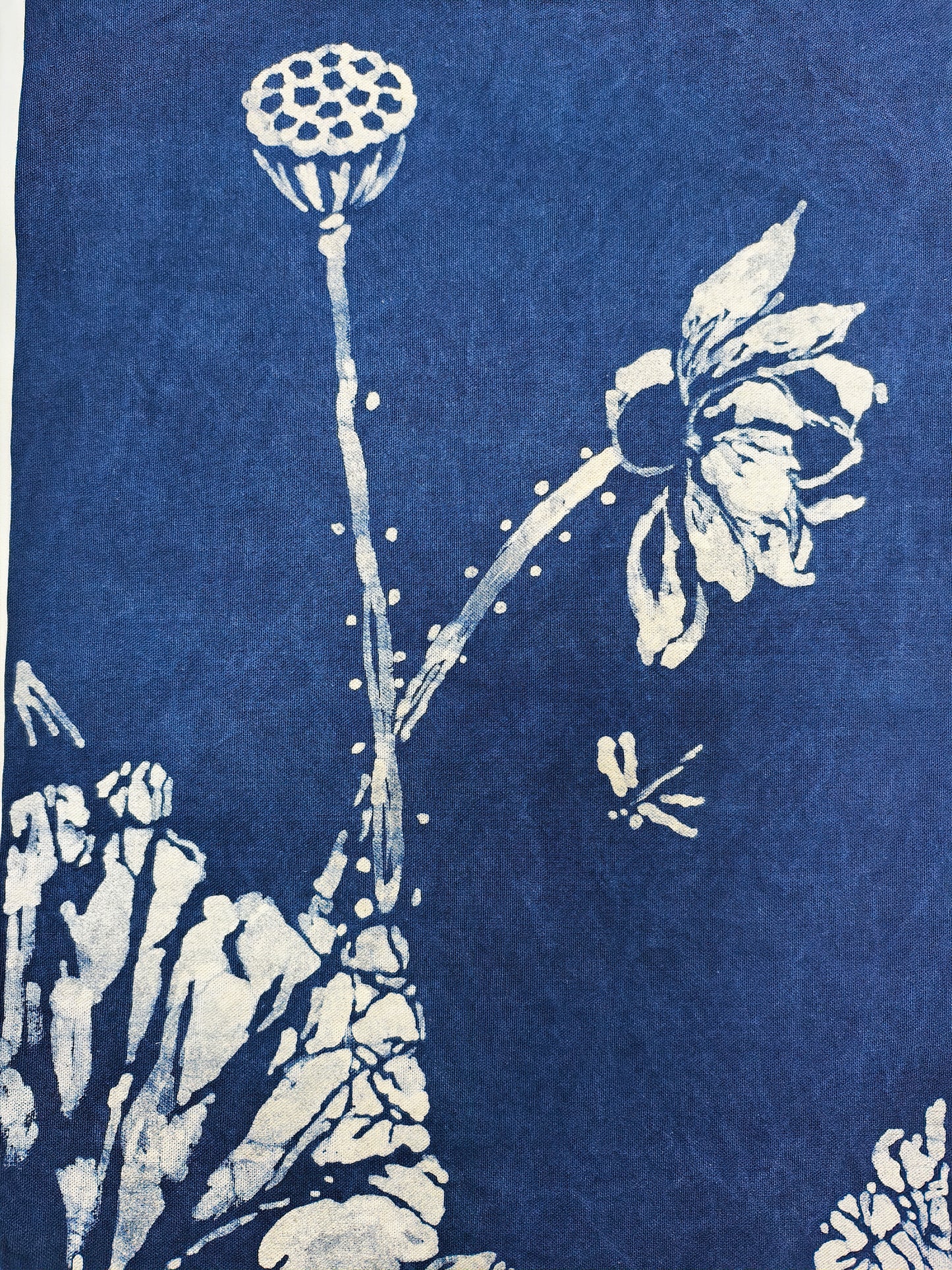 White floral design on a blue fabric background