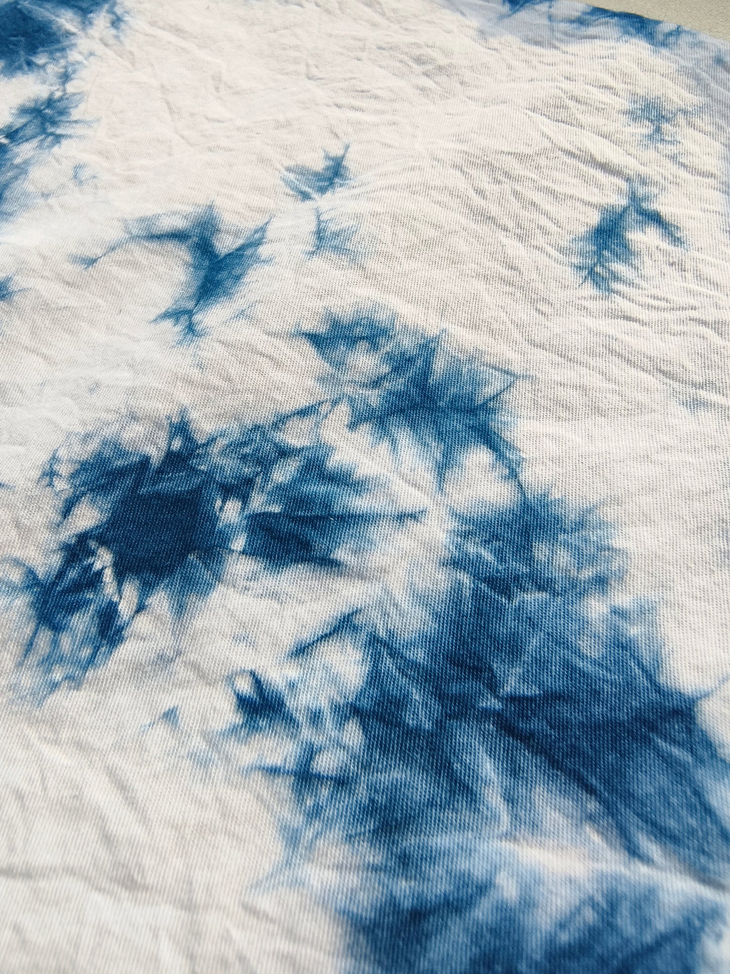 Close-up of blue and white tie-dye fabric texture
