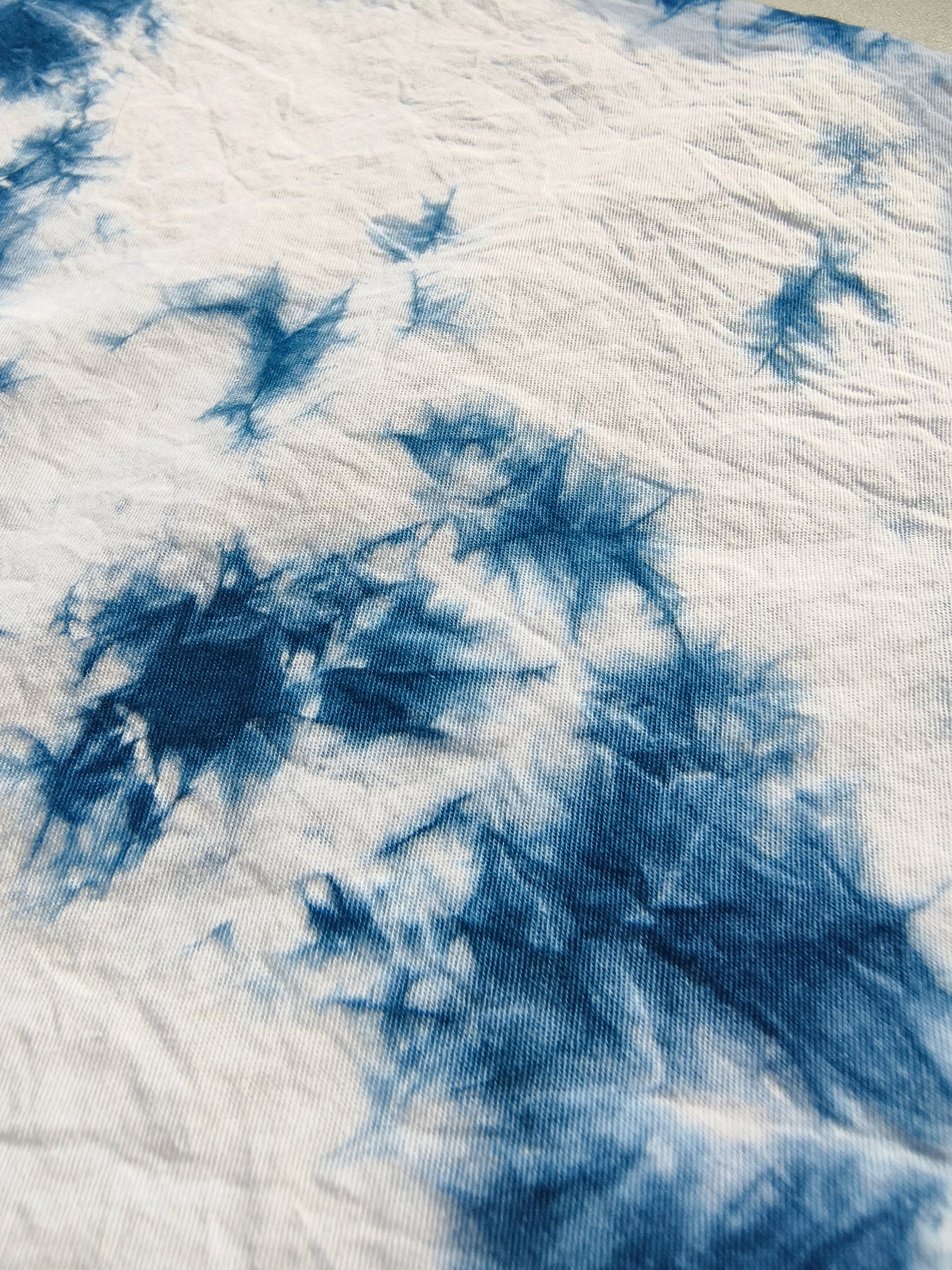 Close-up of blue and white tie-dye fabric texture