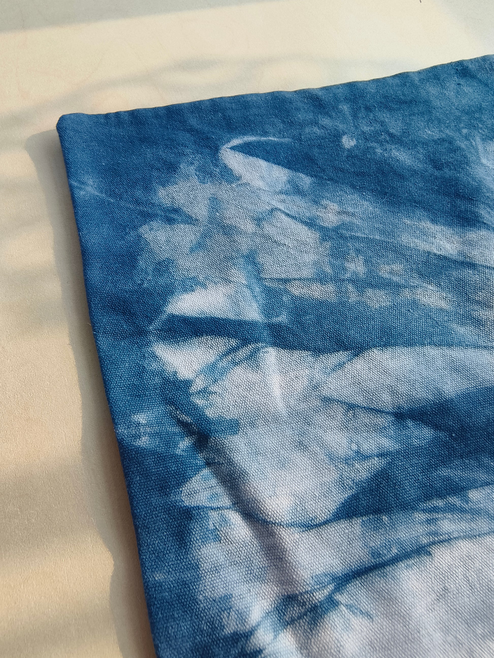 Blue tie-dye fabric on a light background
