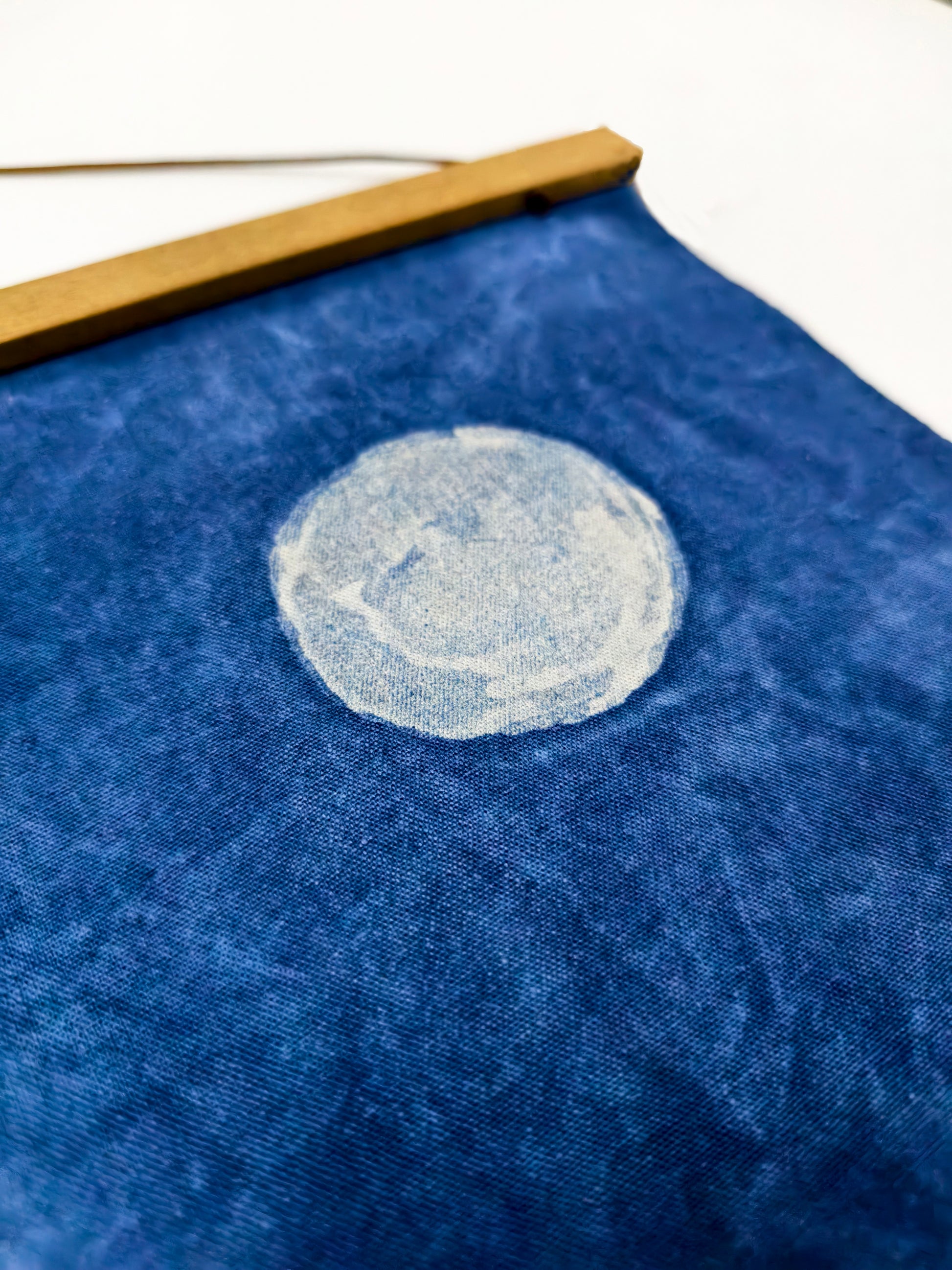Blue fabric with a white circular design on a white background