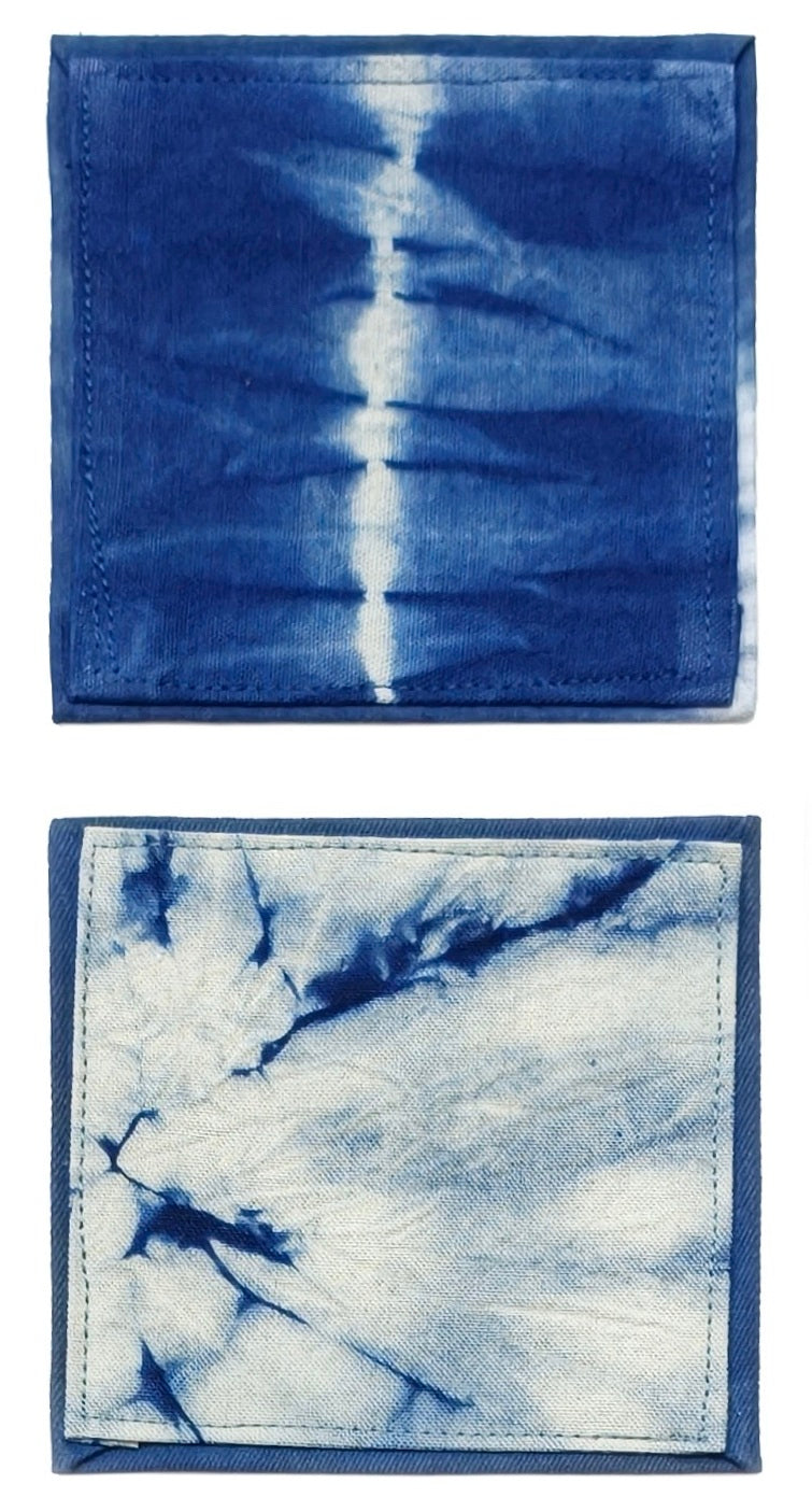 Two tie-dye fabric swatches, one blue and white, the other white and blue, on a white background.
