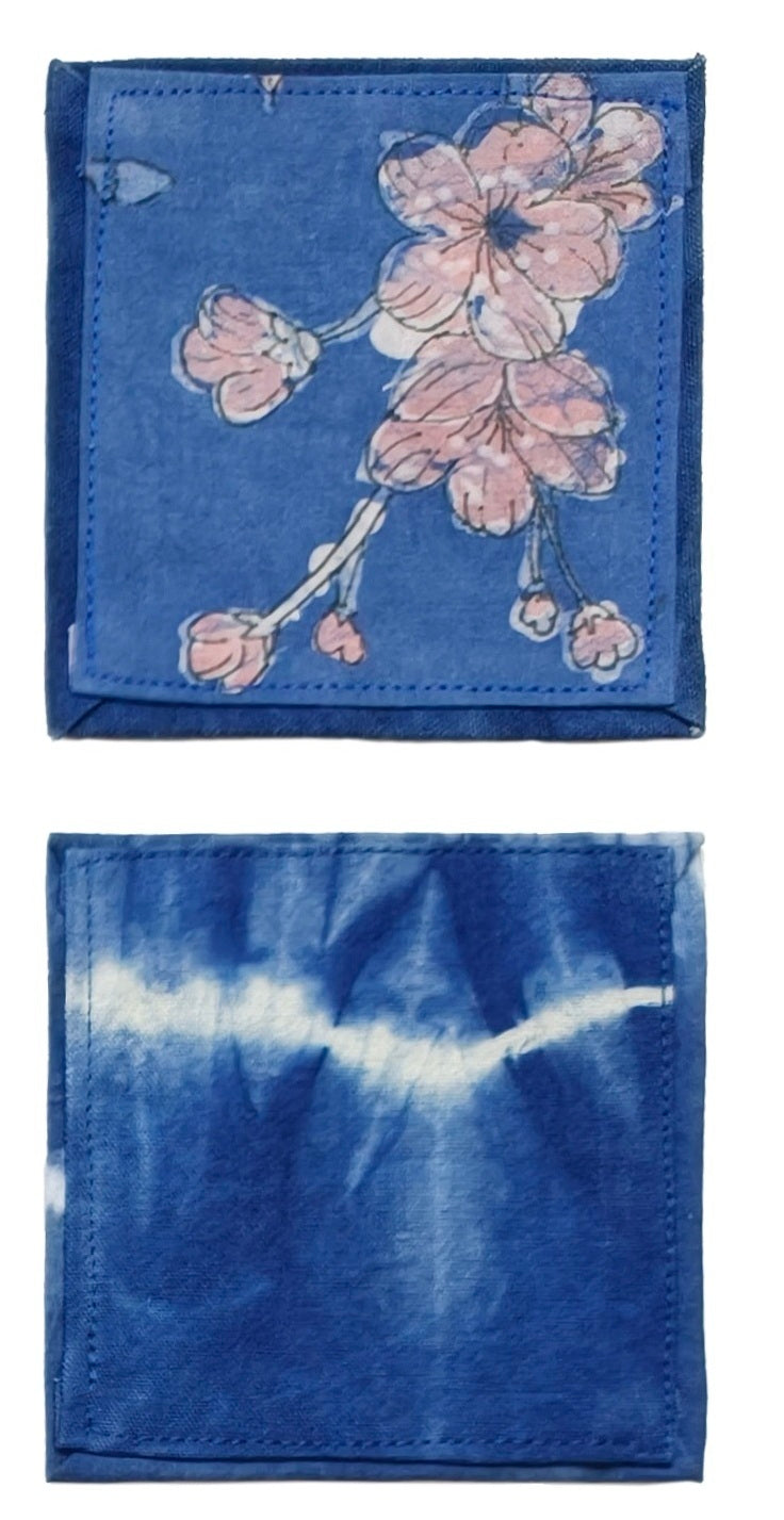 Two blue fabric items with floral and tie-dye patterns on a white background