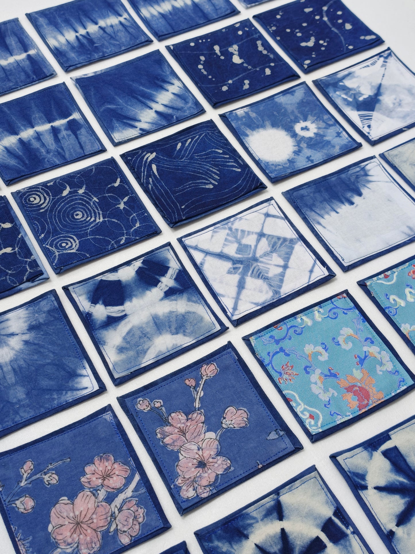 Collection of blue square tiles with various patterns